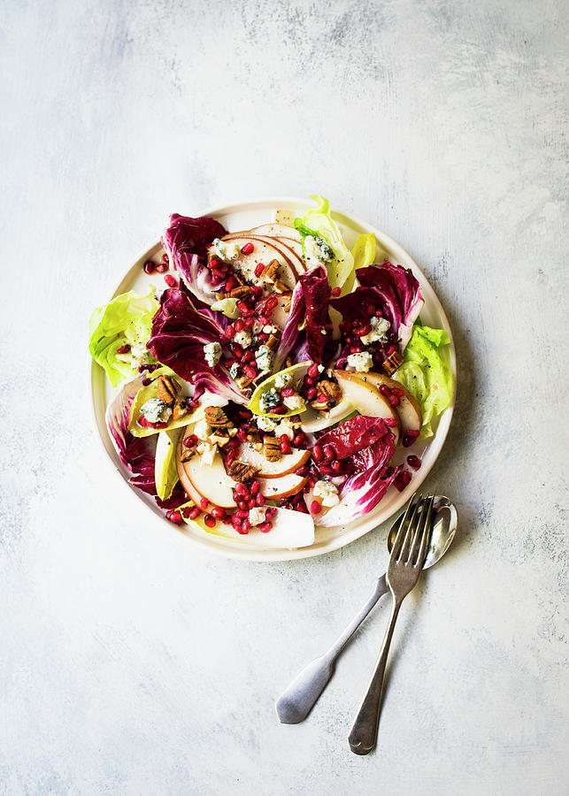 A Radicchio Salad With Chicory, Pears, Gorgonzola And Pomegranate Seeds Photograph by Lisa Rees
