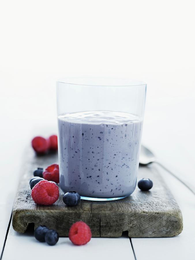 A Raspberry And Blueberry Smoothie Photograph by Mikkel Adsbl