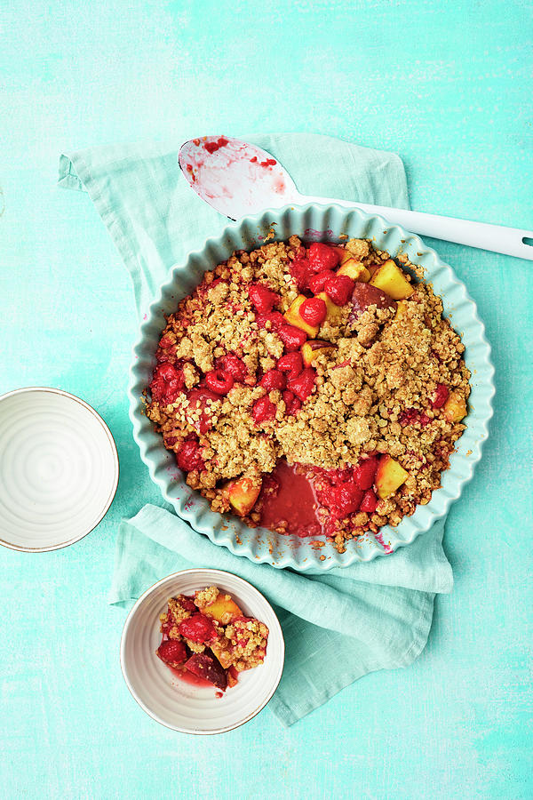 A Raspberry And Peach Crumble Topped With Oat Crumbles Photograph by Stockfood Studios / Andrea Thode Photography