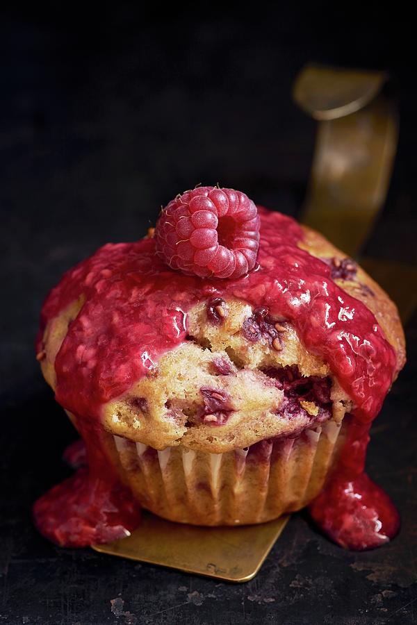 A Raspberry Muffin Garnished With Raspberry Sauce And A Single Raspberry close Up Photograph by Ulrike Emmert