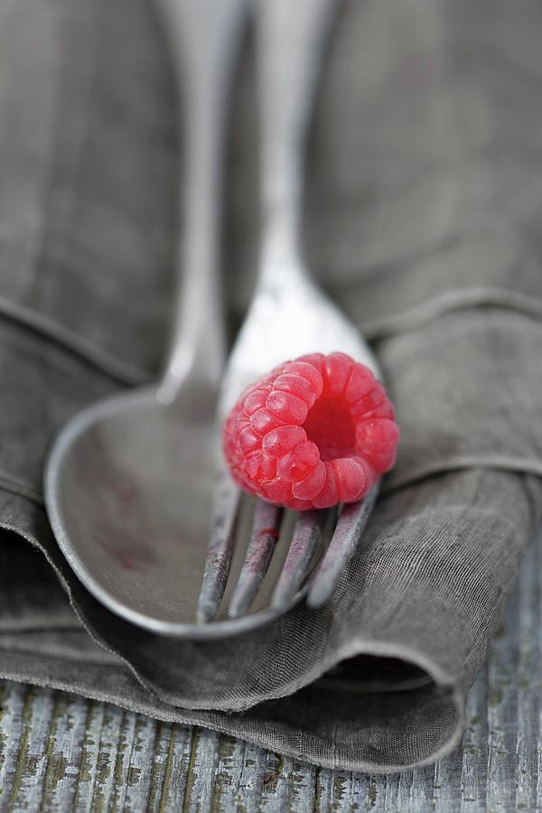 A Raspberry On Silver Cutlery Photograph by Martina Schindler