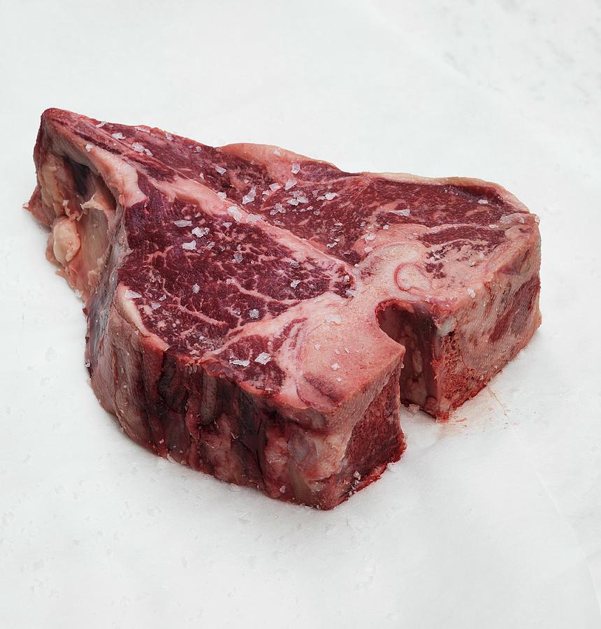 A Raw Beef Steak With Salt Photograph by Hugh Johnson