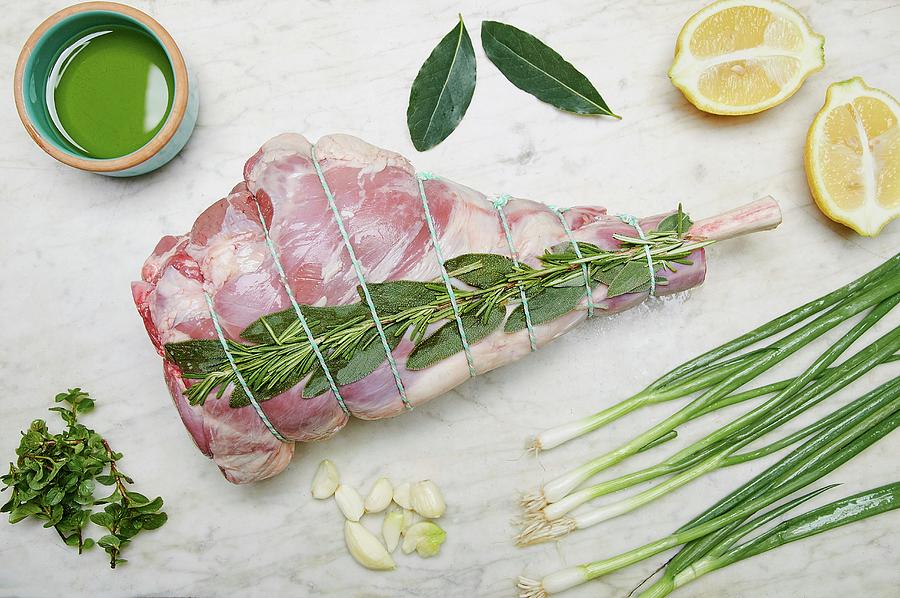 A Raw Leg Of Lamb With Ingredients Photograph by Fred + Elliott  Photography