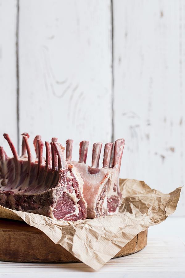 A Raw Rack Of Lamb On A Piece Of Paper Photograph by Sarah Coghill