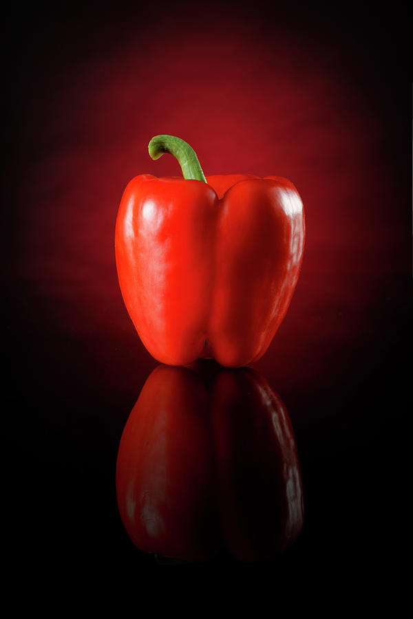 A Red Pepper Against A Red And Black Background Photograph by Petr Gross