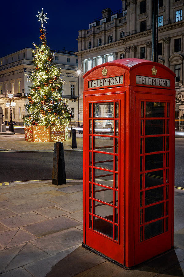 A phone booth in London on a beautiful night at Christmas. Photograph by George Afostovremea