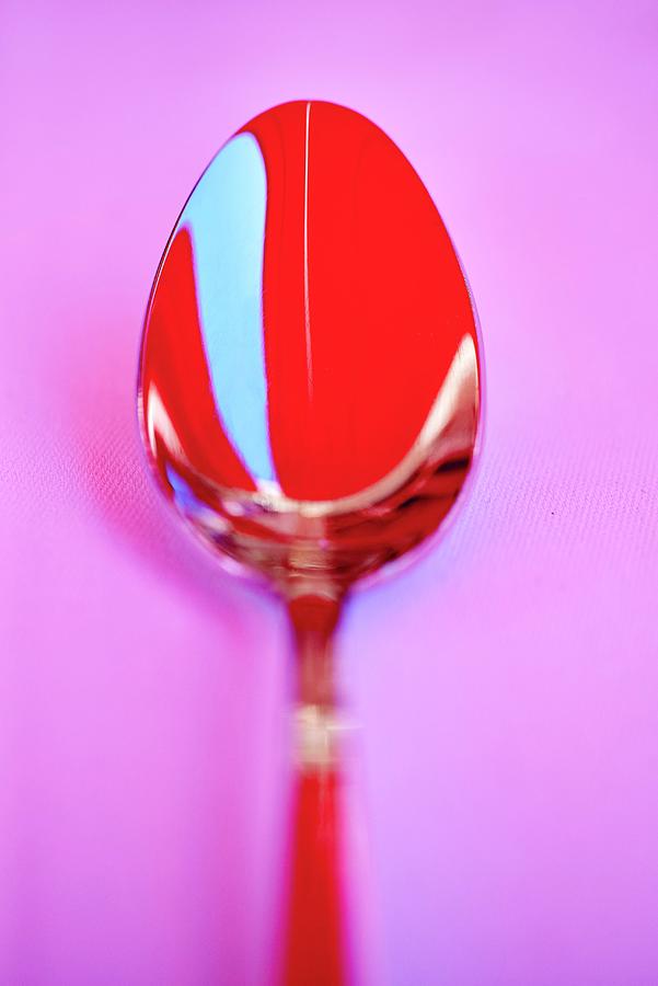 A Red Spoon On A Pink Surface Photograph by Bernhard Winkelmann