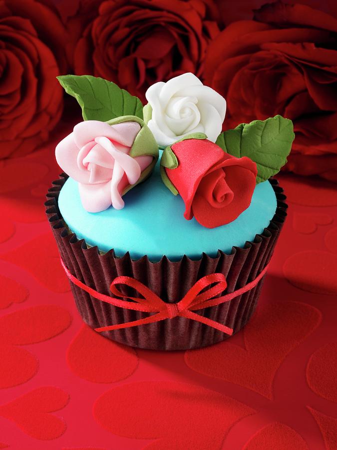 A Red Velvet Cupcake With Sugar Roses Photograph by Foodfolio