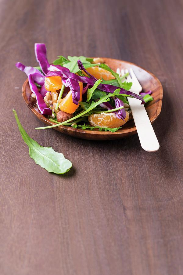 A Rocket And Red Cabbage Salad With Nuts, Wheat And Tangerines Photograph by Mandy Reschke