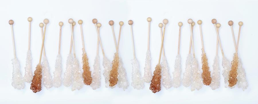 A Row Of Brown And White Rock Sugar Sticks Photograph by Peter Garten