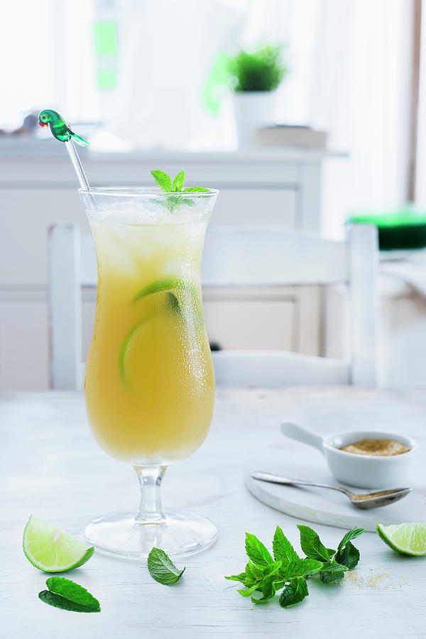 A Rum Cocktail With Lime, Peppermint And Pineapple Juice Photograph by Maricruz Avalos Flores