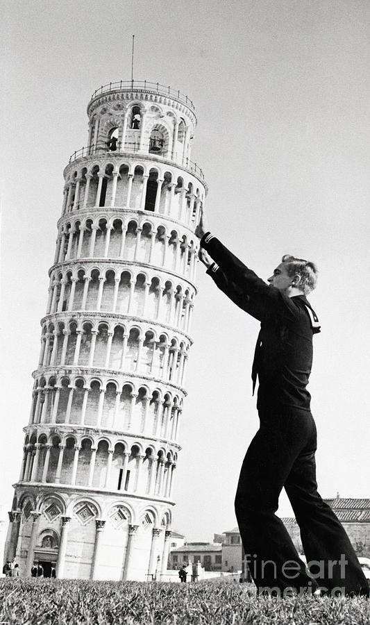 A Sailor Holds Up The Leaning Tower Photograph by Bettmann