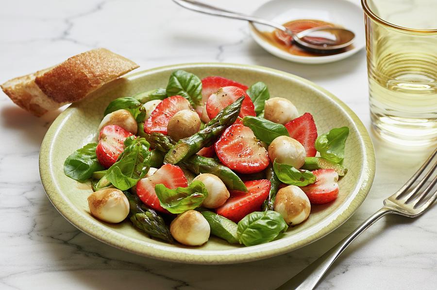 A Salad With Green Asparagus, Strawberries, Mini Mozzarella Balls And Fresh Basil Photograph by Ulrike Emmert