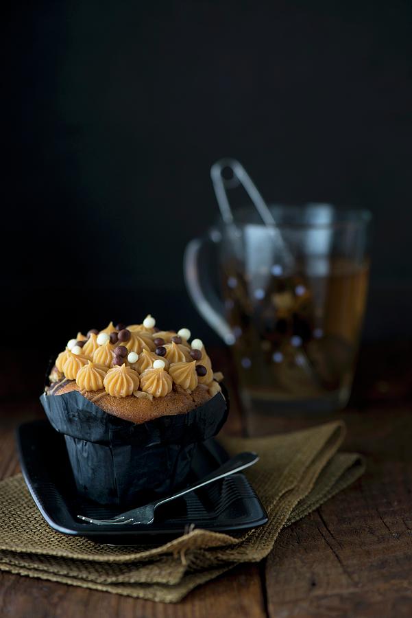 A Salted Caramel Cupcake With A Cup Of Herbal Tea Photograph by Jamie Watson