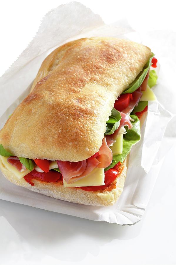 A Sandwich Filled With Drycured Ham, Salad And Cheese Photograph by