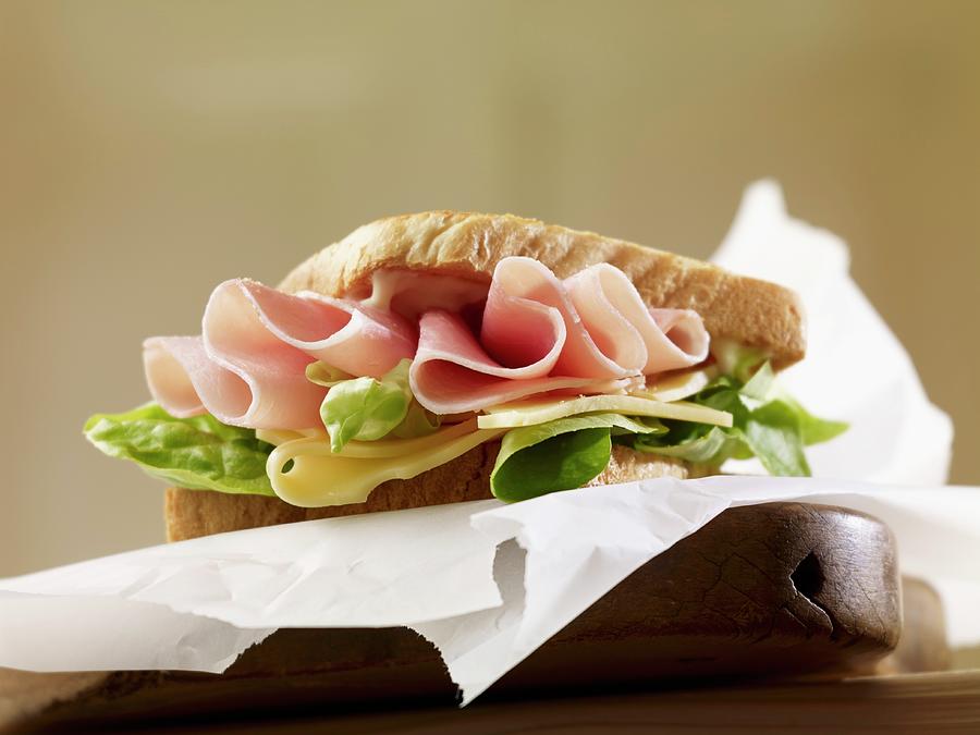 A Sandwich Filled With Ham, Cheese And Lettuce Photograph by Studio R. Schmitz