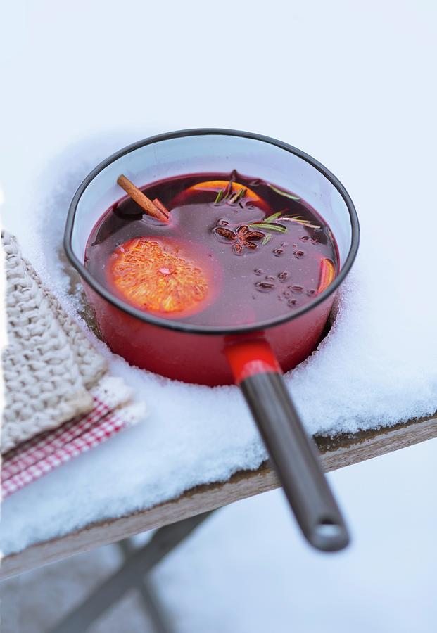 A Saucepan Of Mulled Wine And Orange Slices In The Snow Photograph by Jalag / Wolfgang Schardt