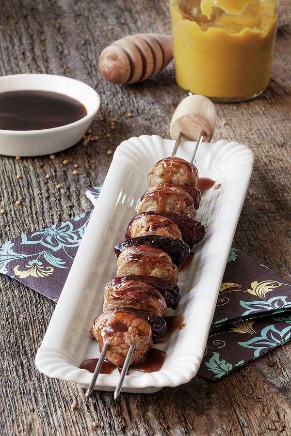 A Sausage Kebab With Dates And A Honey Mustard Sauce Photograph by Birgit Twellmann