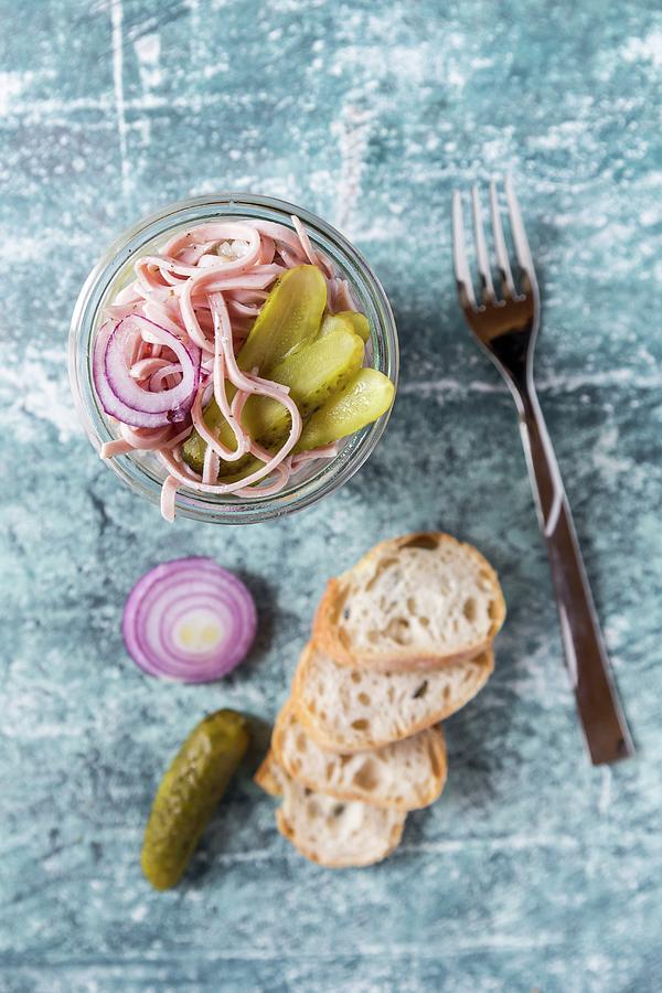 A Sausage, Red Onion And Gherkin Salad In A Glass, With Baguette Slices Photograph by Sandra Rsch