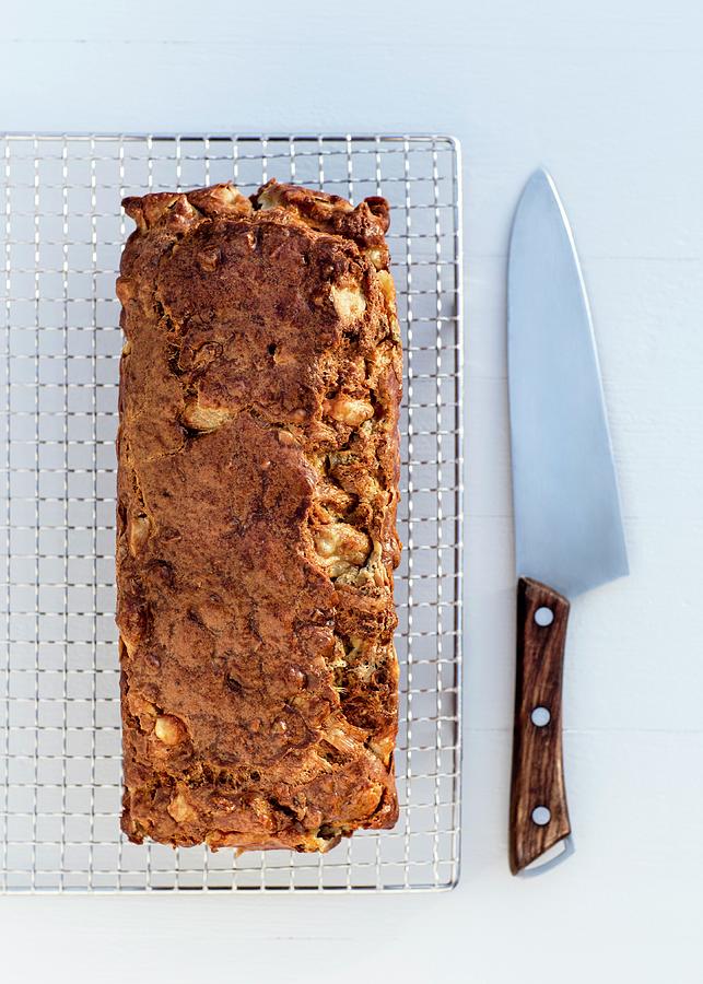 A Savoury Pear And Walnut Cake On A Wire Rack Photograph by Julia Hildebrand