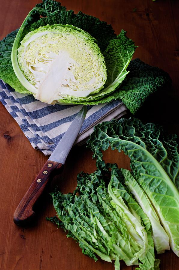 A Savoy Cabbage Halved And Cut Into Strips Photograph by Jamie Watson