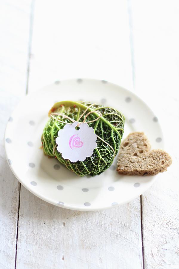 A Savoy Cabbage Parcel And A Heart-shaped Slice Of Bread Photograph by Sylvia E.k Photography