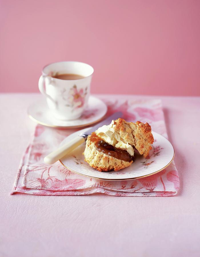 A Scone With Jar, Clotted Cream And A Cup Of Coffee Photograph by Jonathan Gregson
