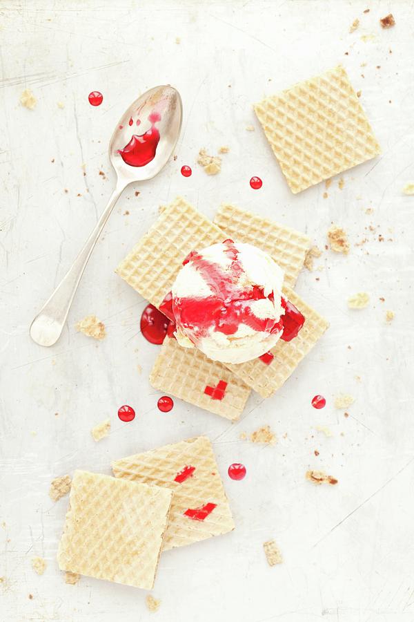 A Scoop Of Ice Cream On Wafer Biscuits With A Red Fruit Sauce Photograph by Jane Saunders