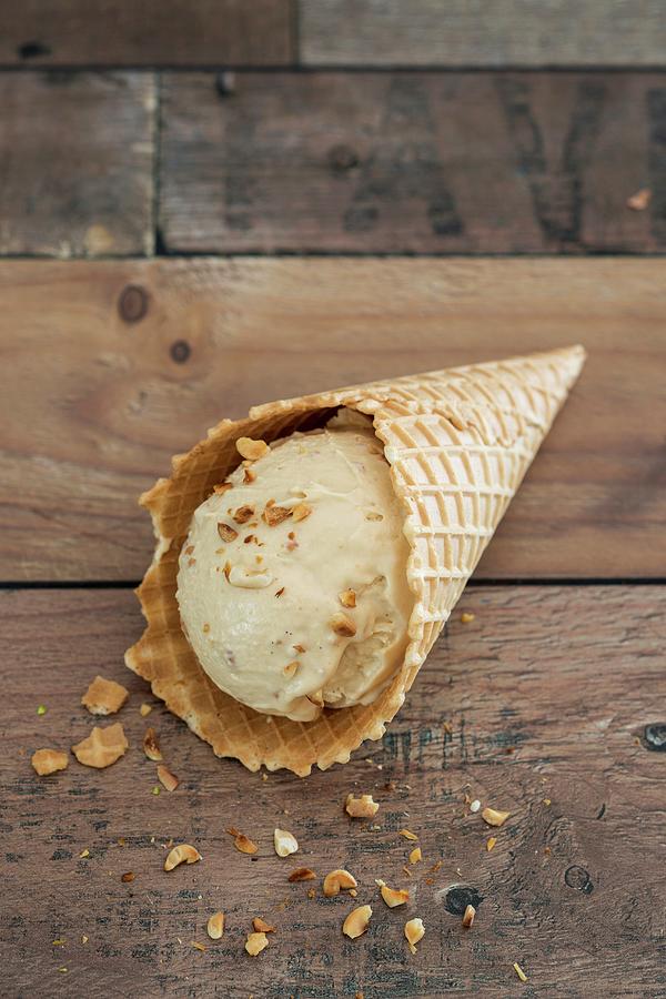 A Scoop Of Peanut Ice Cream In An Ice Cream Cone Photograph by Jan Wischnewski