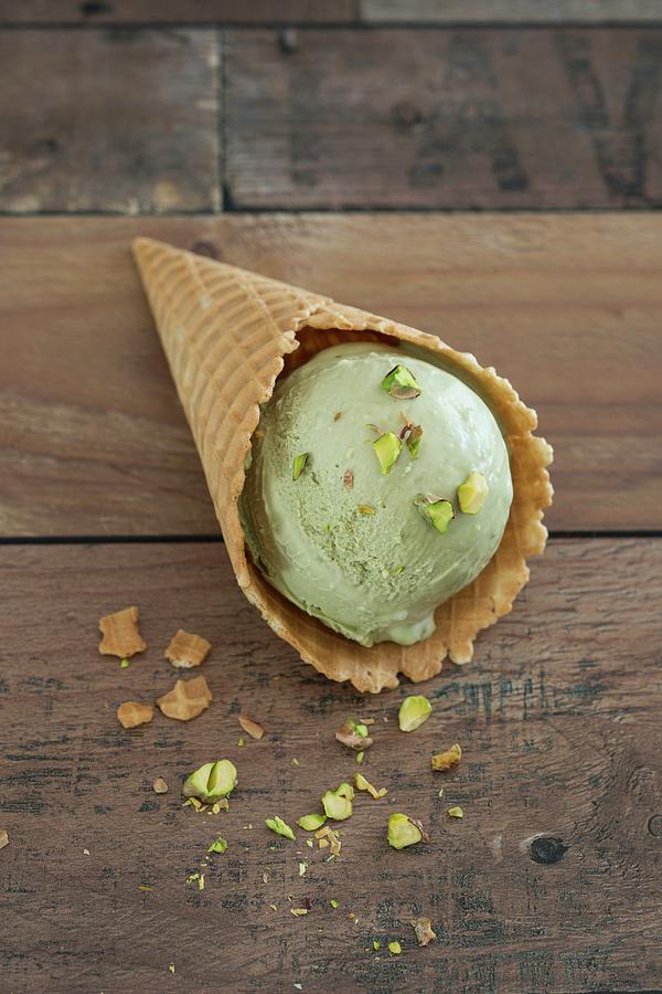 A Scoop Of Pistachio Mascarpone Ice Cream In A Cone Photograph by Jan Wischnewski