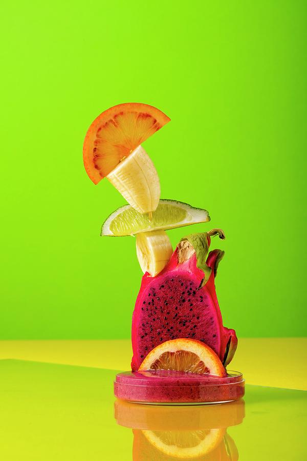 A Sculpture Made From Exotic Fruit Against A Coloured Background Photograph by Jan Prerovsky