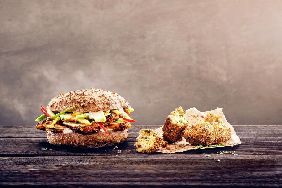 A Seeded Roll With Cajun Chicken Breast And Falafel, Avocado, Apple And Mayonnaise Photograph by Thorsten Kleine Holthaus