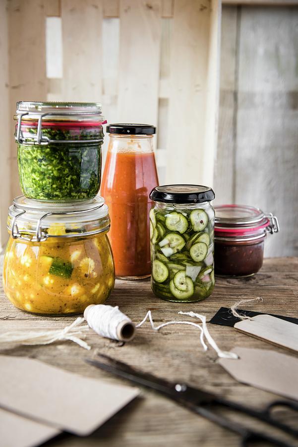 A Selection Of Jars With Pesto, Ketchup, Piccalilli, Chutney And Gherkins Photograph by Magdalena Hendey