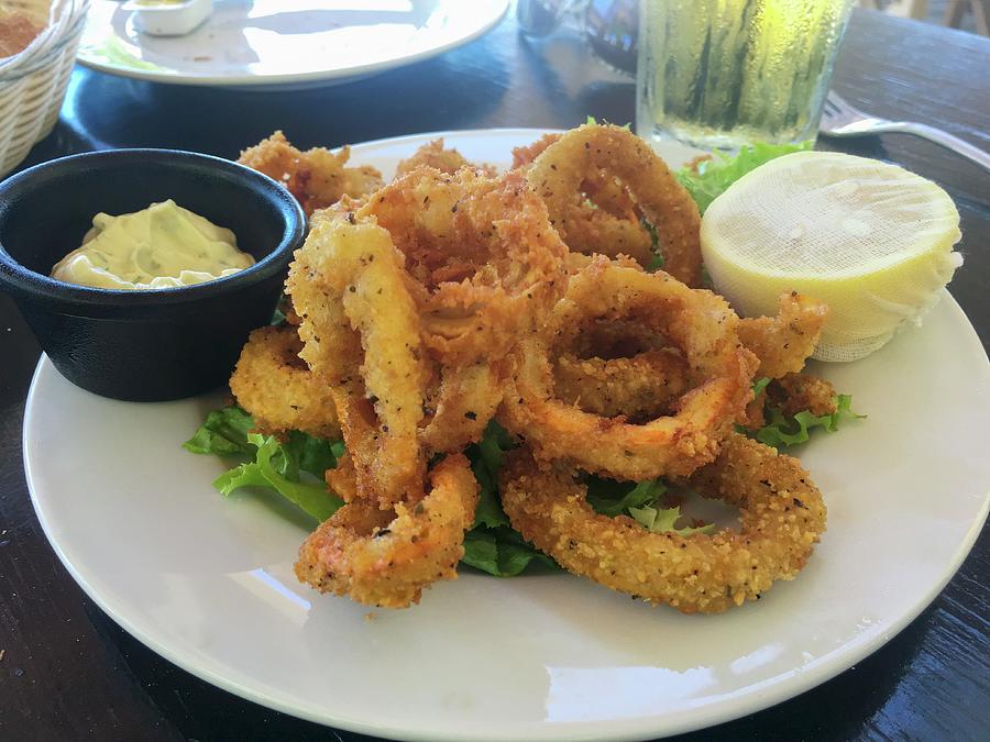 A Serving Of Fried Calamari Rings On A White Plate With A Lemon And Dipping Sauce Photograph by Albert P Macdonald