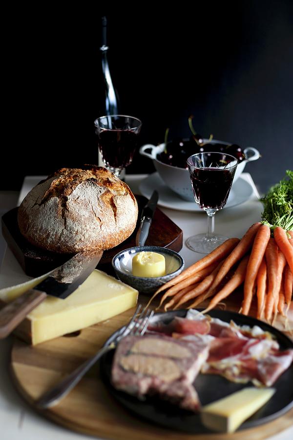 A Set Table With Red Wine, Charcuterie, Carrots, Butter, Cheese And Bread Photograph by Eva Lambooij