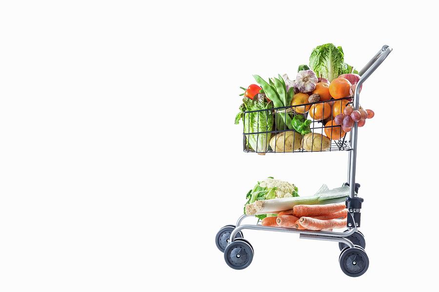 A Shopping Trolley Full Of Fresh Fruit And Vegetables Photograph by Jean-paul Chassenet