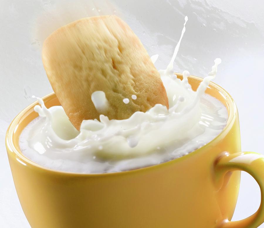 A Shortbread Biscuit Falling Into A Cup Of Milk Photograph by Piga & Catalano S.n.c.