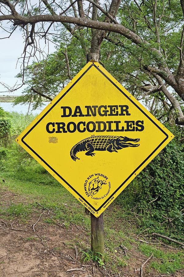 A Sign Warning Of Crocodiles In The Isimangaliso Wetland Park, A Wildlife Park In South Africa Photograph by Lukas Larsson Jalag