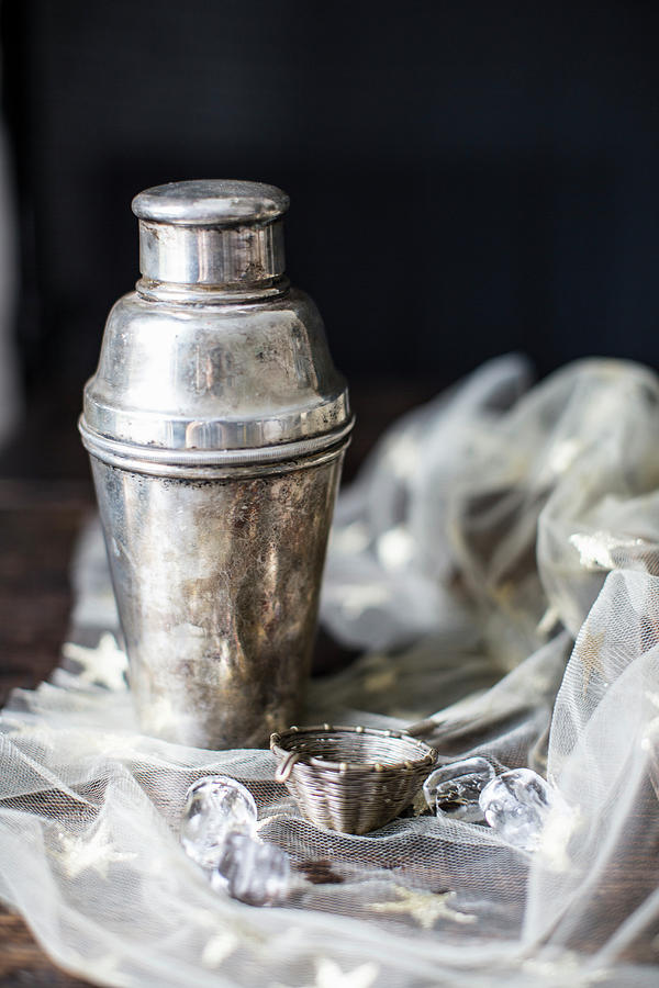 A Silver Cocktail Shaker And Bar Sieve On A Starry Cloth Photograph by Helen Cathcart