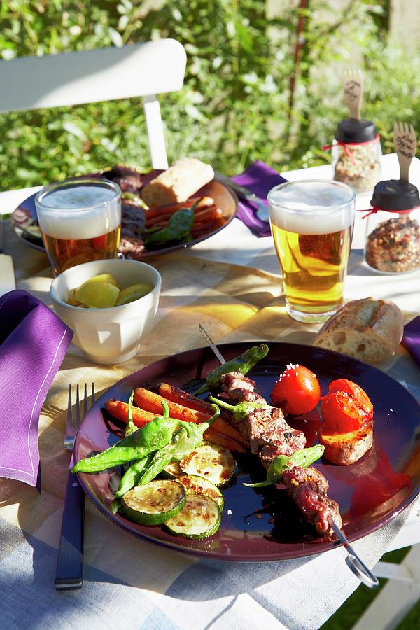 A Skewer And Grilled Vegetables On A Table In A Garden Photograph by Jalag / Olaf Szczepaniak