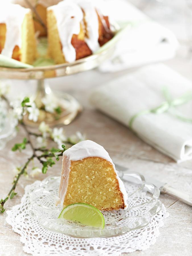 A Slice Of Almond And Lime Cake On A Glass Plate Photograph by Hannah Kompanik