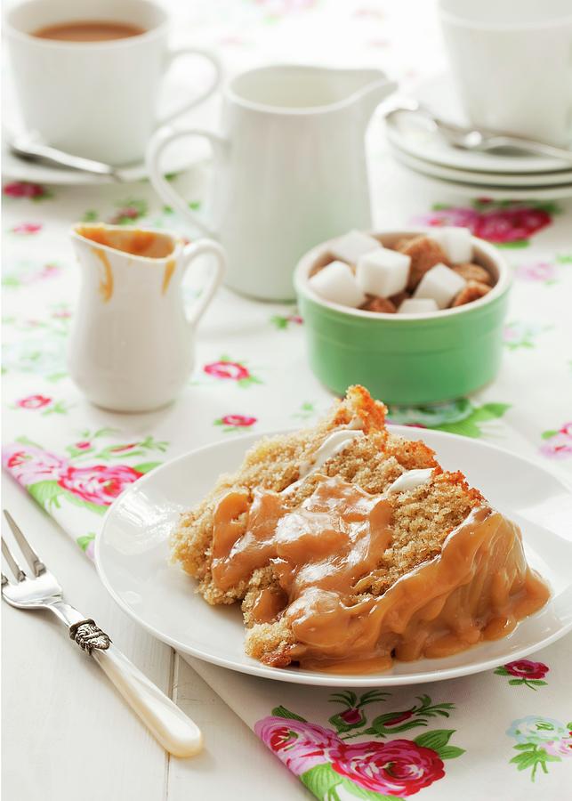 A Slice Of Apple And Cinnamon Sponge Cake With A Caramel Glaze Layer, Sugar Cubes And Tea Photograph by Jane Saunders