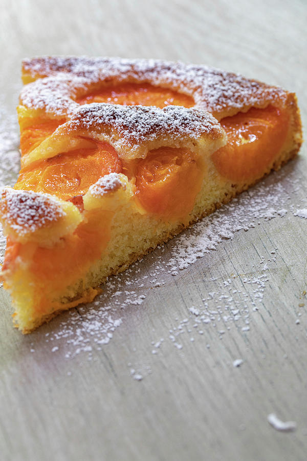 A Slice Of Apricot Cake Dusted With Icing Sugar Photograph by Eising Studio