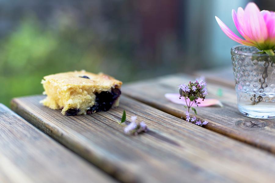 A Slice Of Berry Cake On A Wooden Table Photograph by Agnes Swart