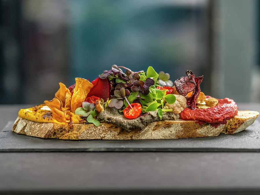 A Slice Of Bread Topped With Spread, Vegetable Crisps And Cress Photograph by Manuel Krug