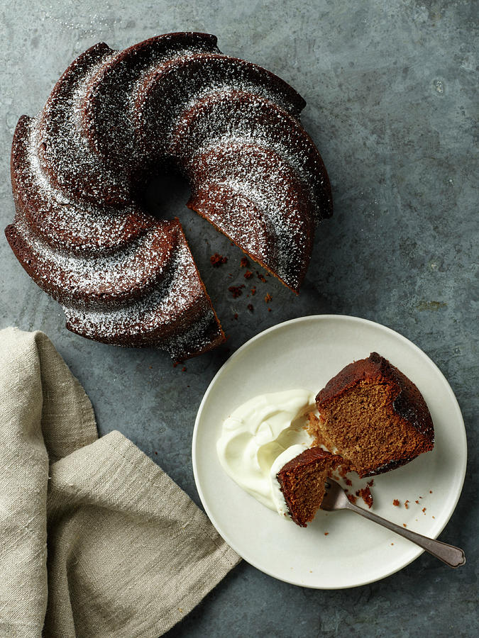 A Slice Of Bundt Cake Served With Cream On A Cake Plate Photograph by James Lee