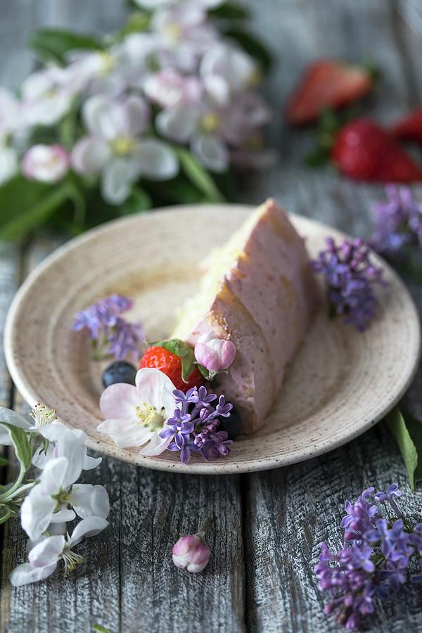 A Slice Of Butter Cream Cake On A Plate Decorated With Flowers And Berries Photograph by Malgorzata Laniak