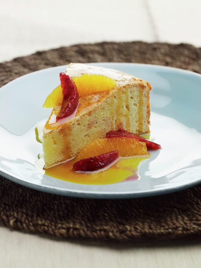 A Slice Of Cake With Blood Oranges, Orange And Citrus Fruit Sauce Photograph by Rene Comet