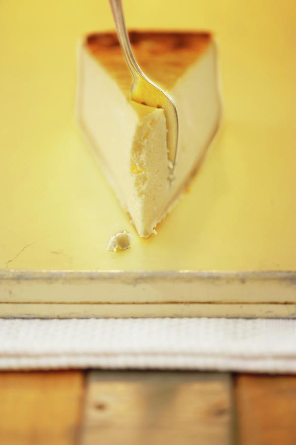A Slice Of Cheesecake With A Cake Fork Photograph by Till Melchior