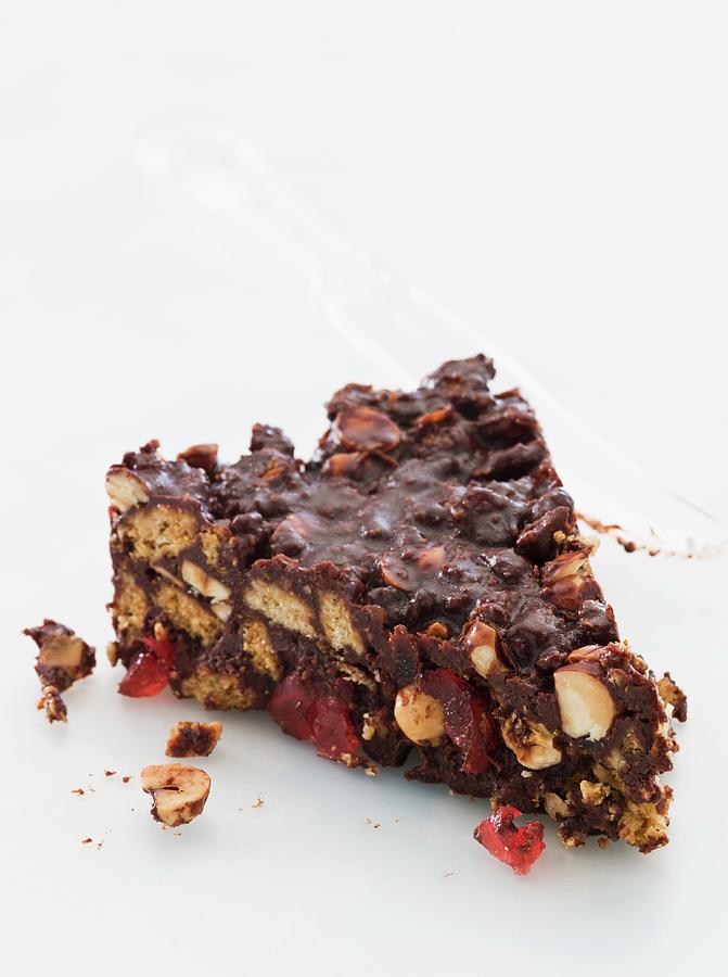 A Slice Of Chocolate Biscuit Cake With Glac Cherries And Nuts Photograph by Lingwood, William